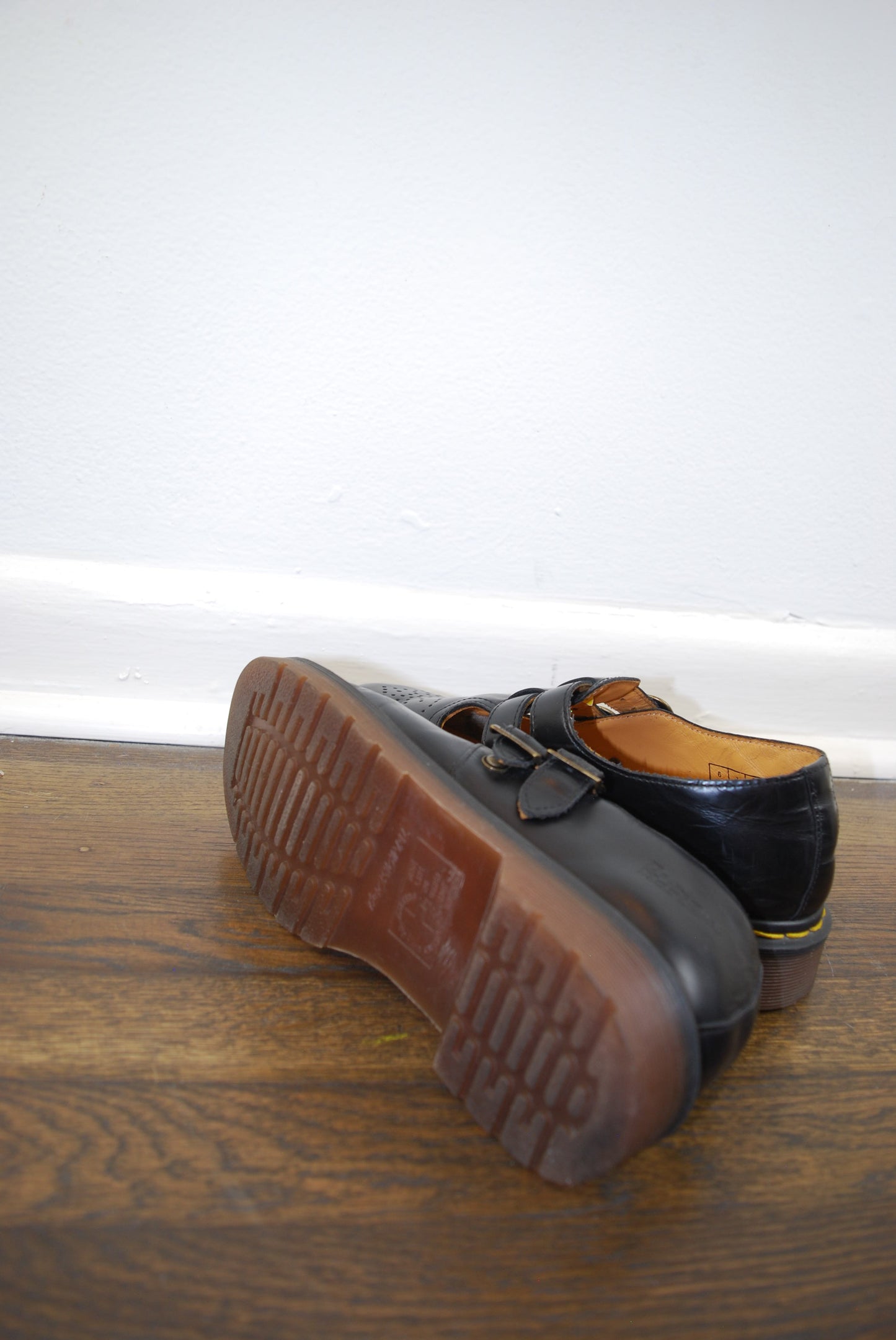 Brown shoe sole pressed against a wooden door