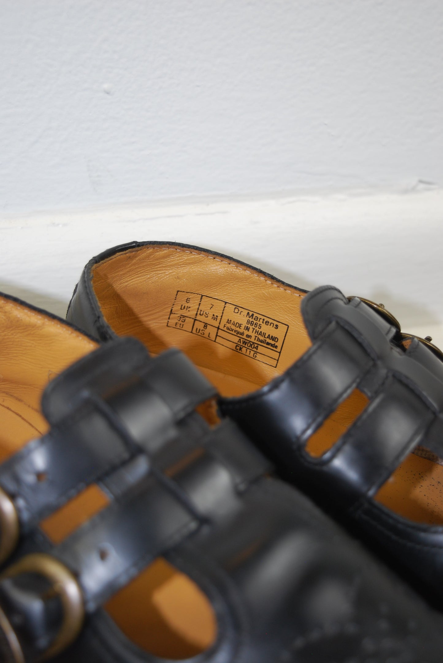 Close-up of black leather sandals with a white background