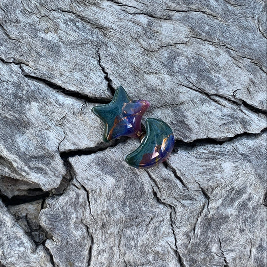 Star-shaped earrings on a textured stone surface