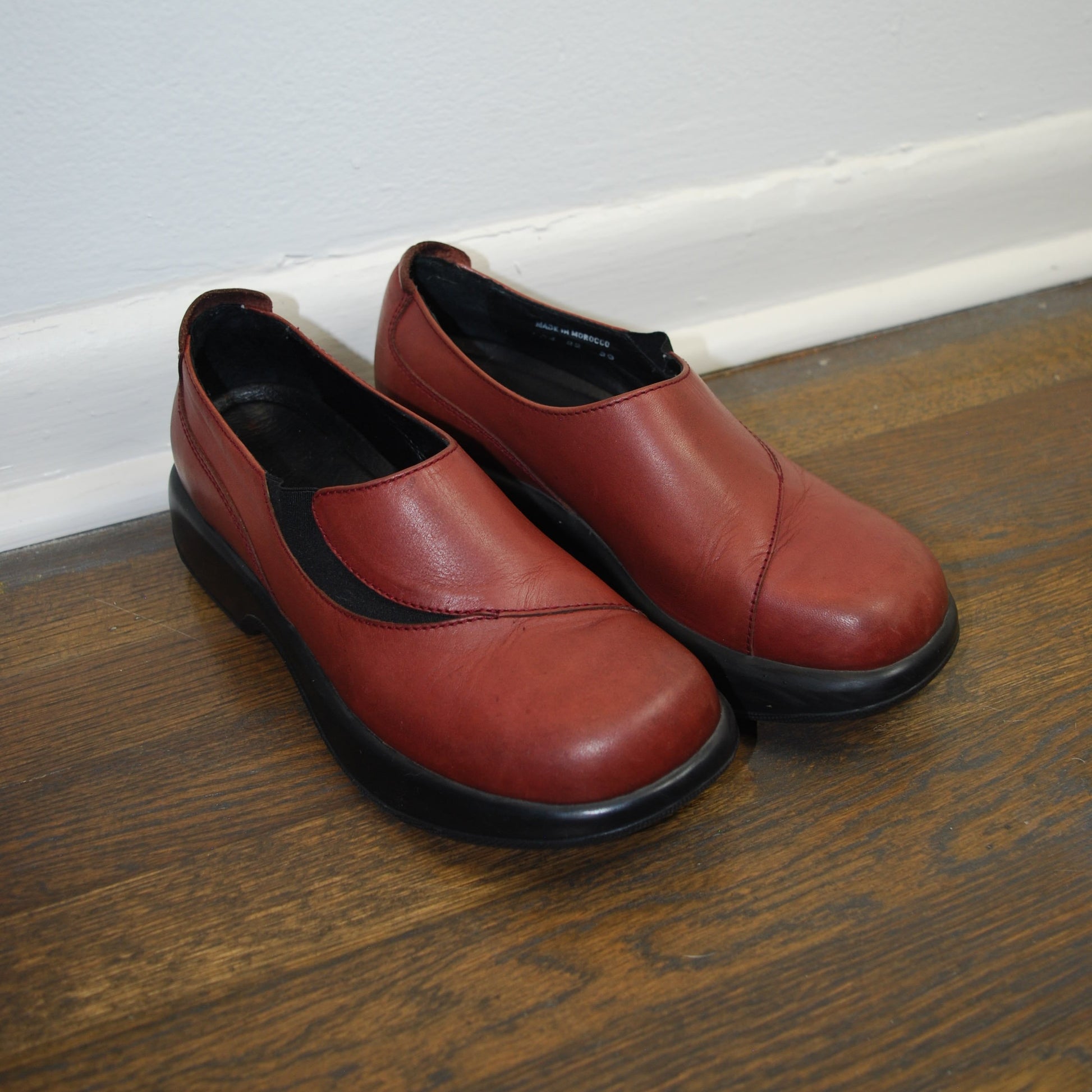 Pair of red shoes on a wooden floor