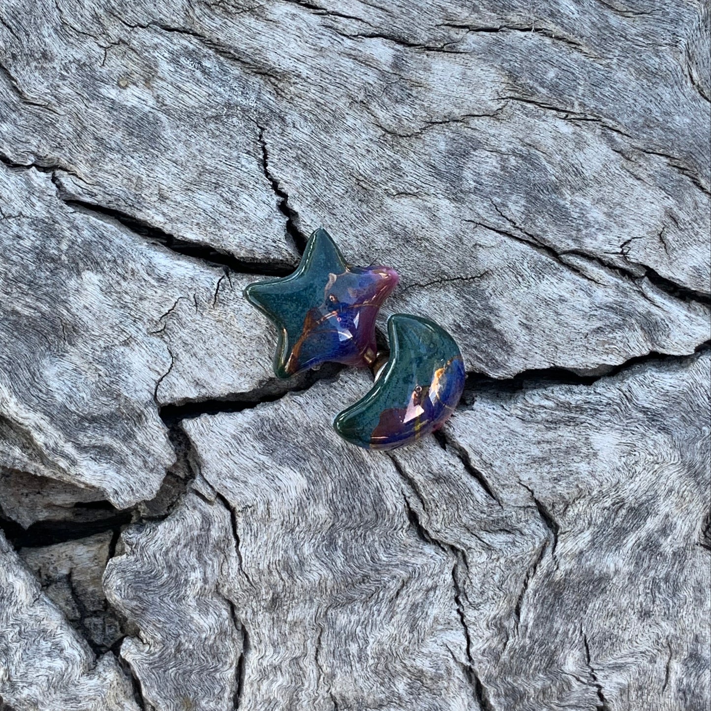 Star-shaped earrings on a textured stone surface