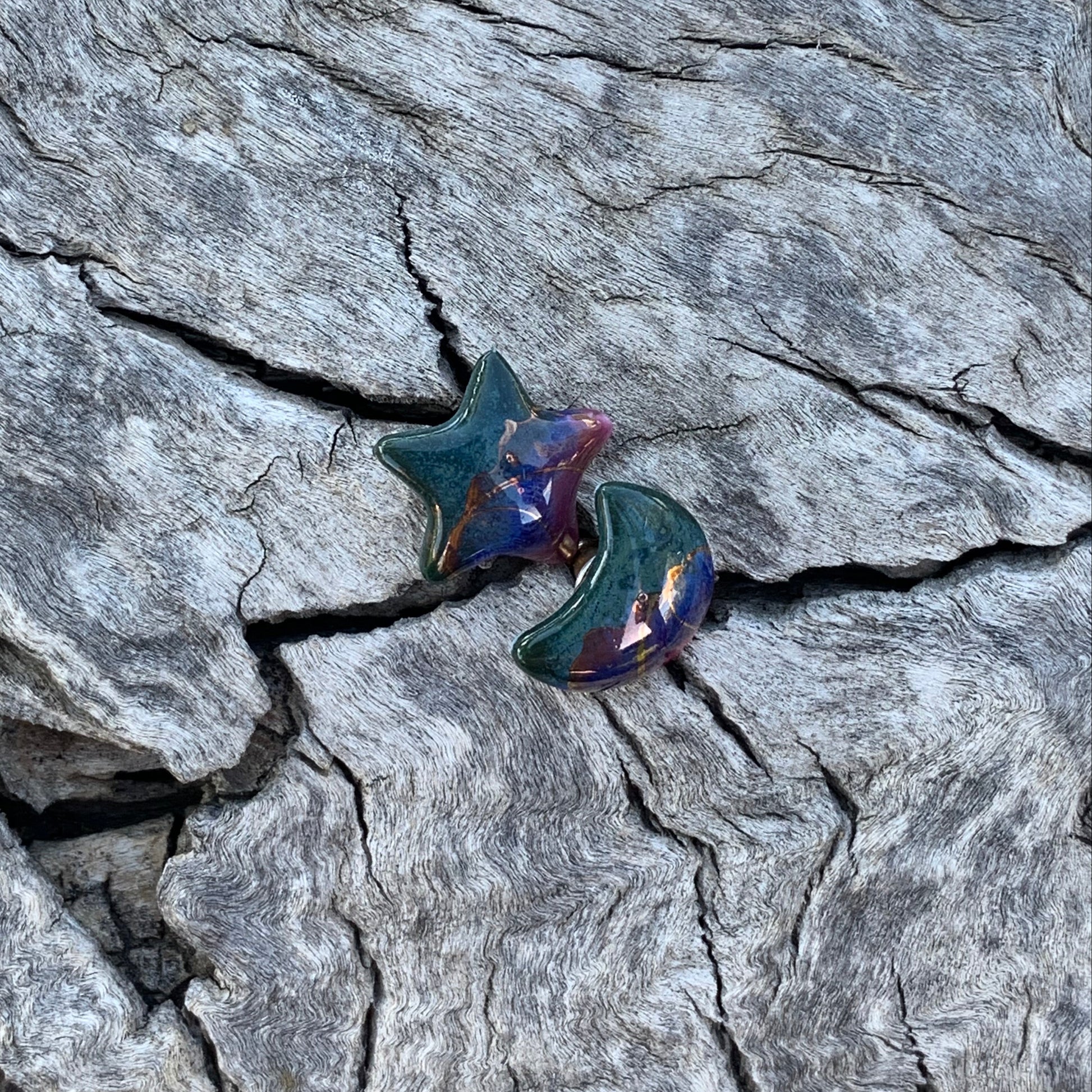 Star-shaped earrings on a textured stone surface