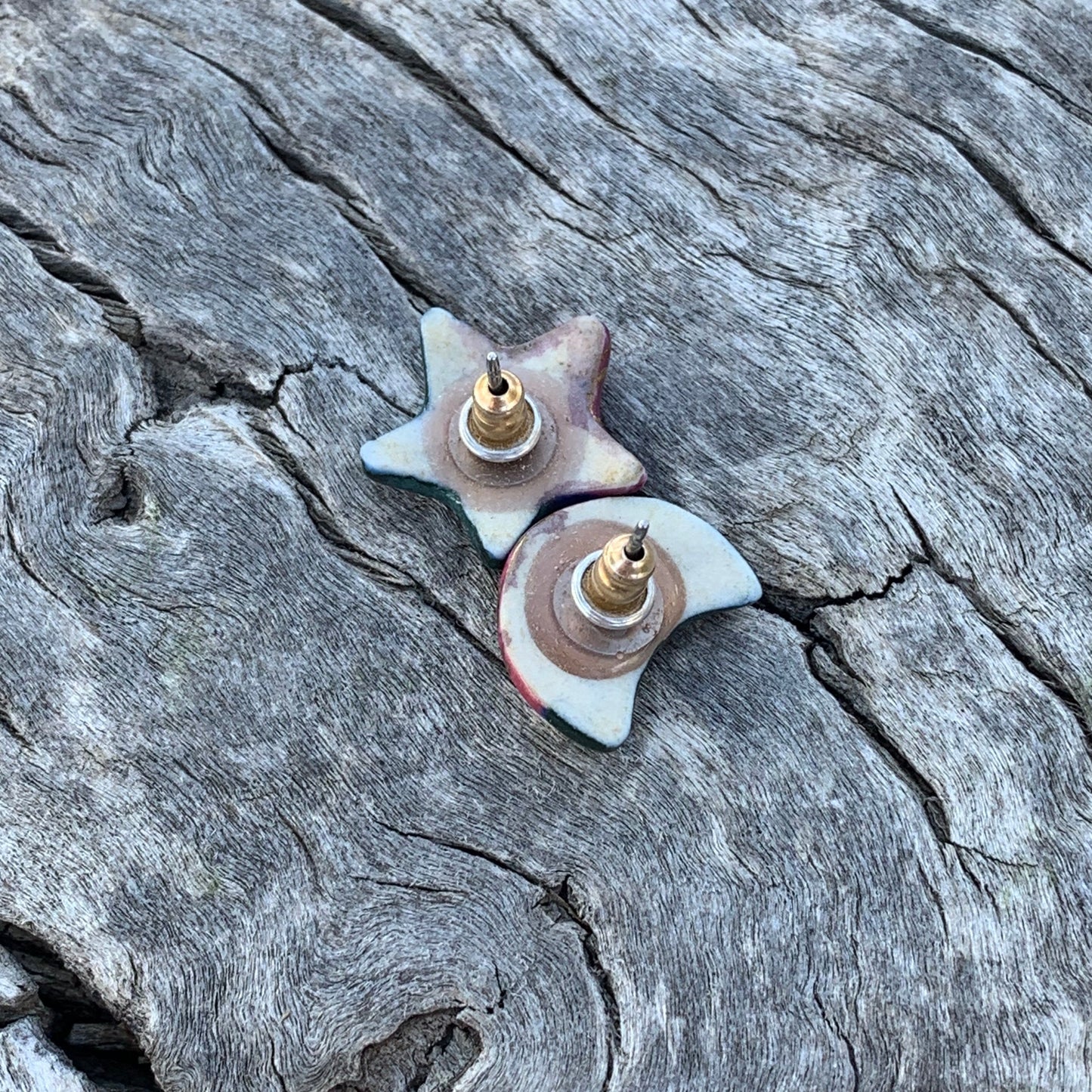 Star-shaped earrings on a textured stone surface